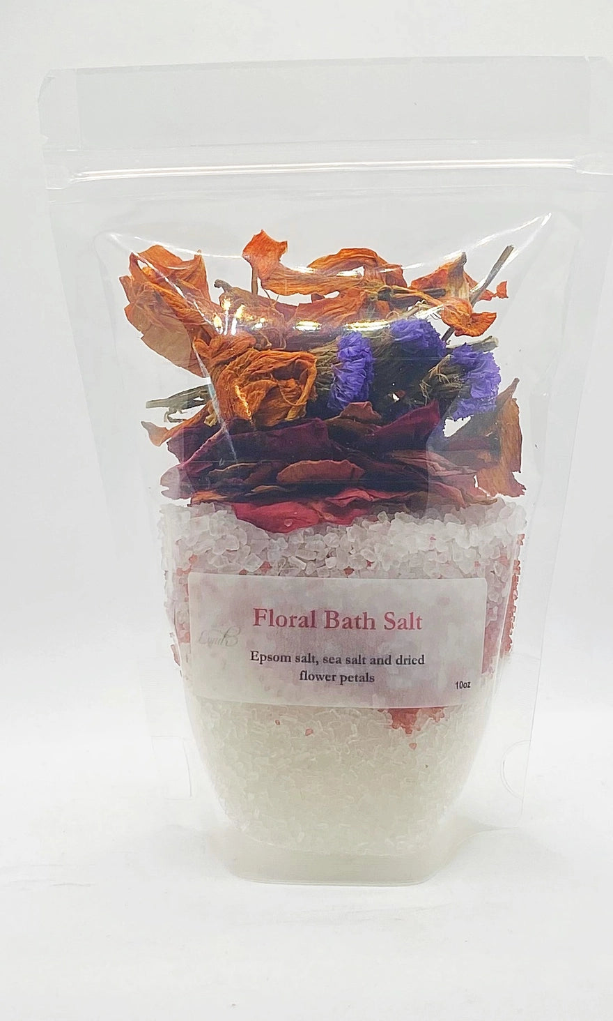Bag of floral bath salts with decorative flowers on a white background