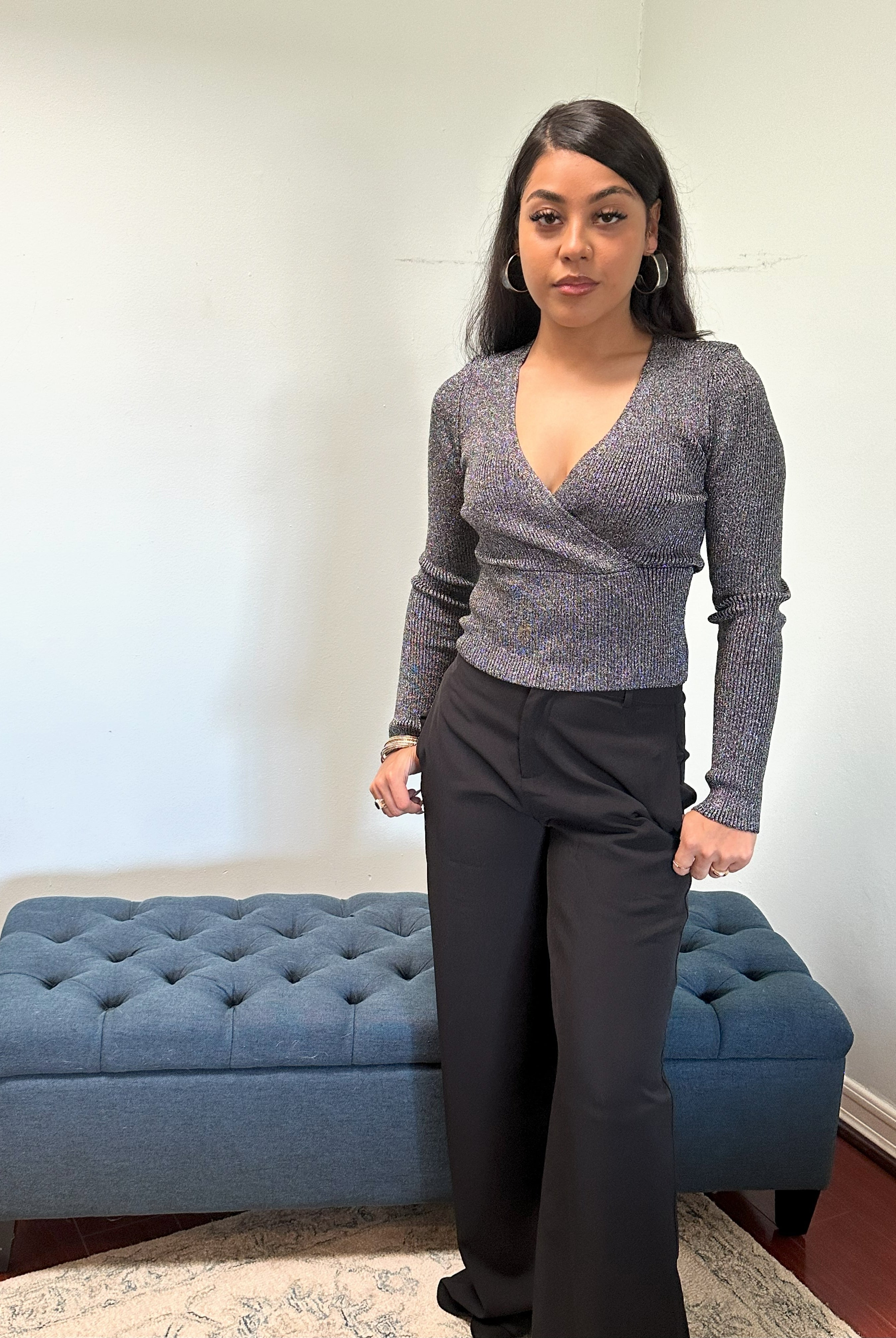 Shimmering metallic ribbed sweater with a fitted silhouette, long sleeves, cross-over V-neck, and a soft stretch fabric