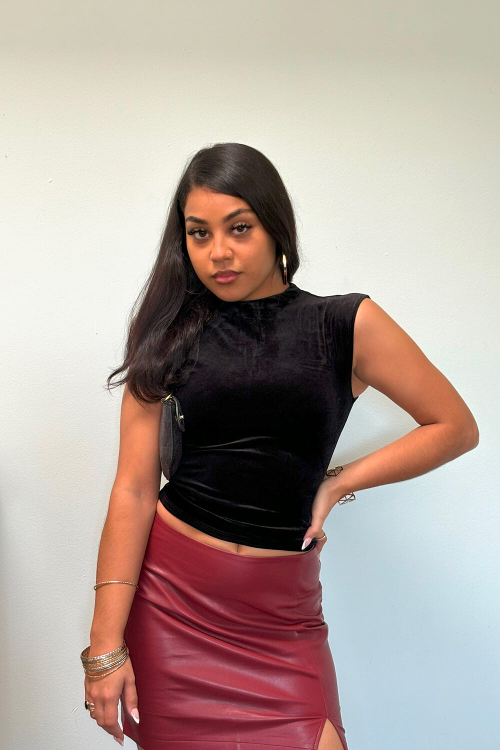 Black velvet crew neck, sleeveless top featuring ruching on the sides